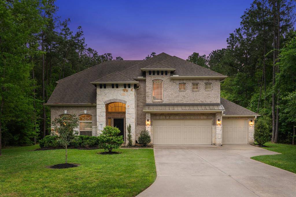 Experience tranquility in this stunning brick and stone home with a 3-car garage, nestled on a spacious one-acre lot within a gated community.