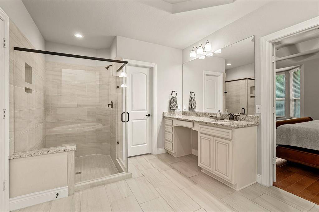 Oversized corner shower and a view of the second vanity.