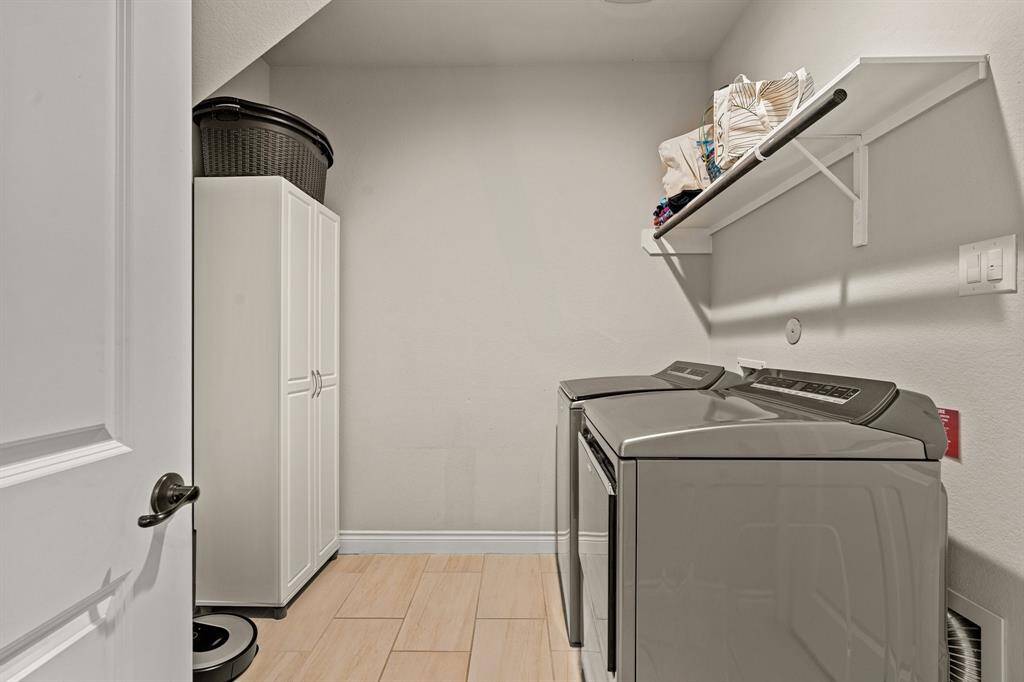 Spacious laundry with extra room for shelving, storage or a refrigerator / freezer.