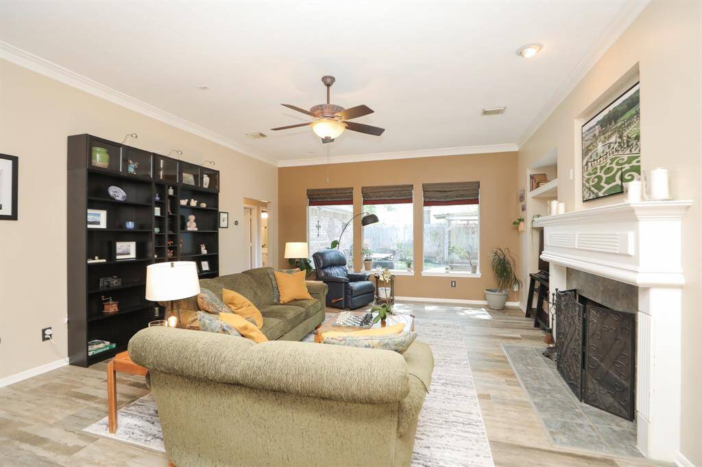 Welcome to your Beautiful Living Room with a Wall of Windows! The black book shelf Stays!