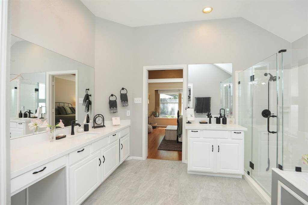 Fully Remodeled Primary Bath. New Quartz Countertops, all New Fixtures, New Glass Shower Door, New Floors, and New Paint.
