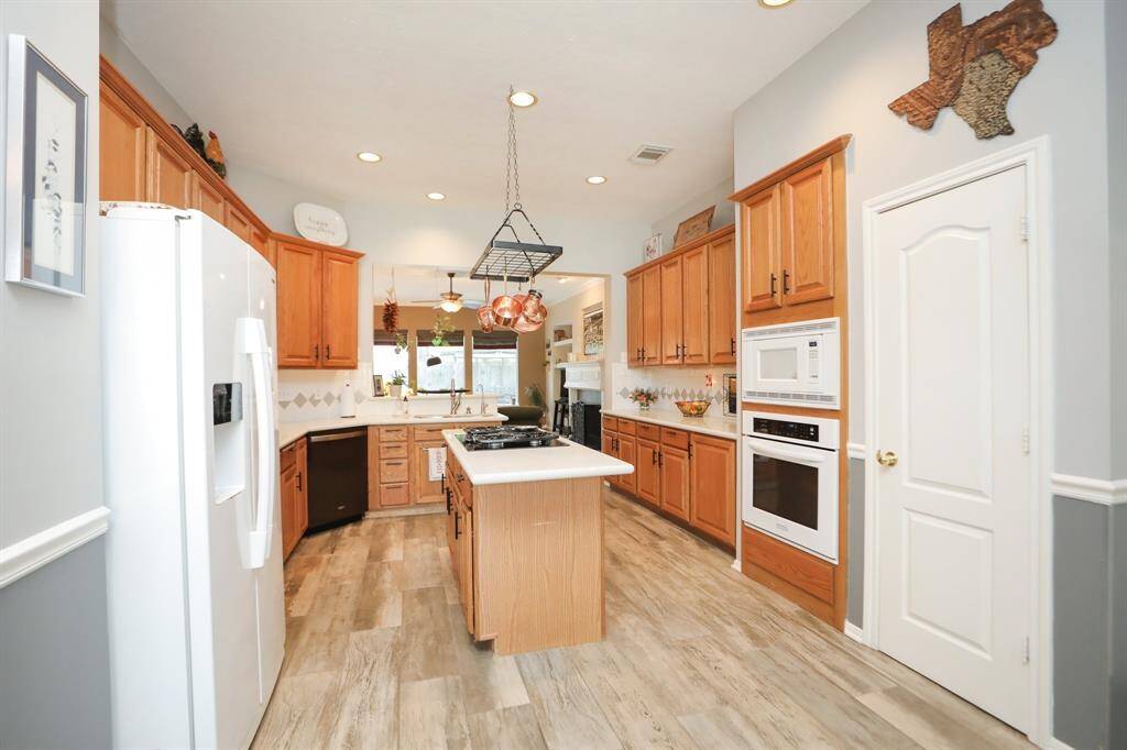 Beautiful Kitchen with Gas Cooktop. Silestone Countertops with plenty of cabinet space with a large pantry. A hanging Cook Rack stays above the stove. New Upper and Lower Convection Kitchen Aid Ovens. Refrigerator Stays.