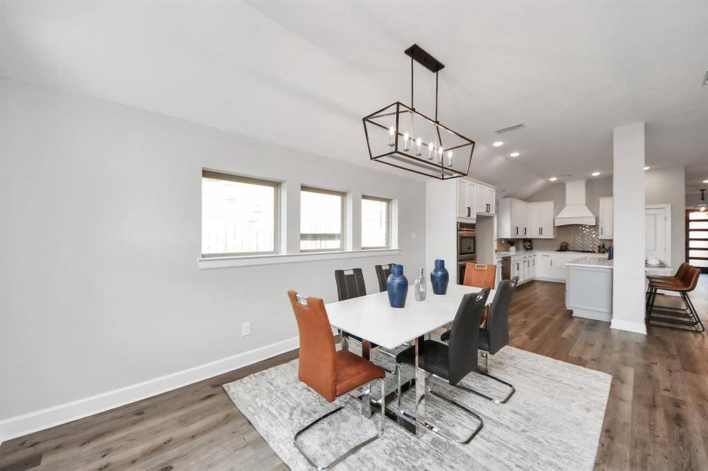 The dining area flows seamlessly into the kitchen, creating an open and connected space ideal for everyday living and entertaining.