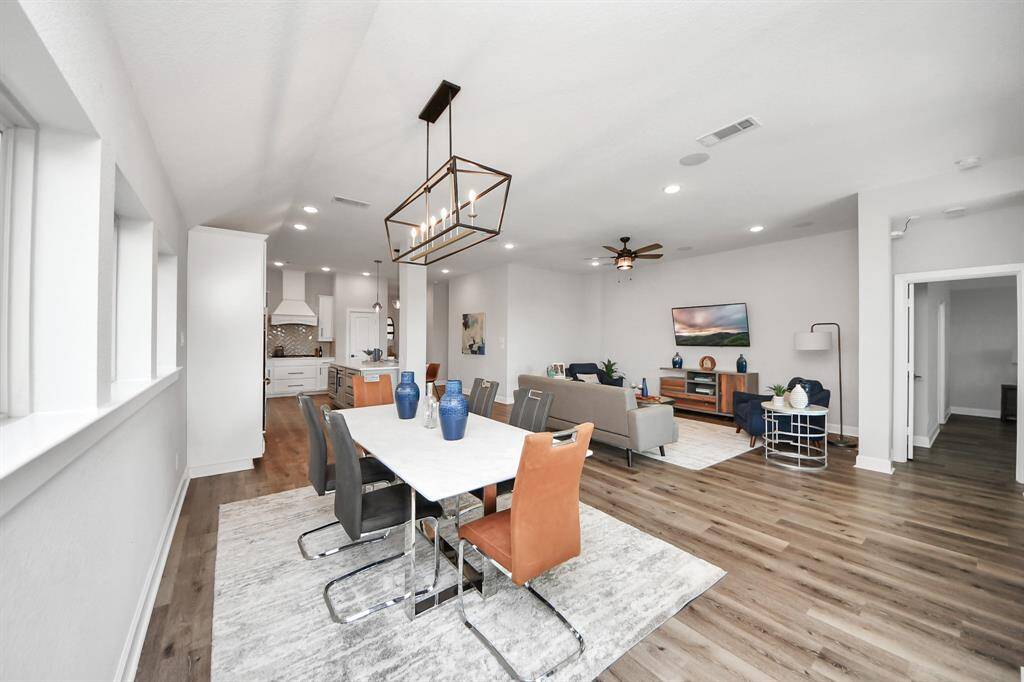 A modern open-concept layout with seamless flow between the living room, dining area, and kitchen.