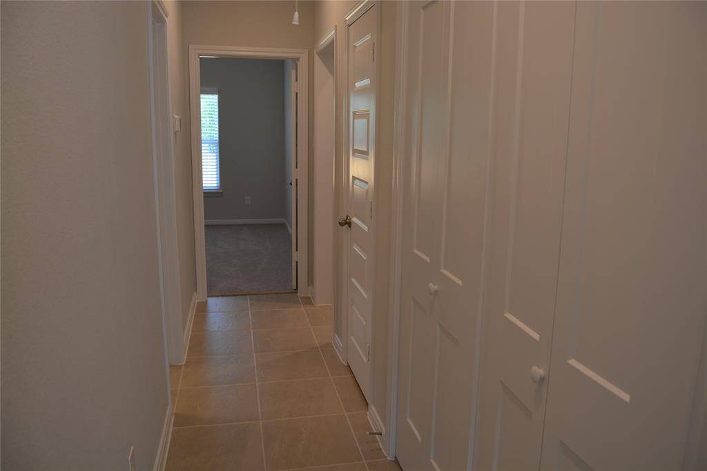 A linen closet and the washer and dryer are located in the hallway