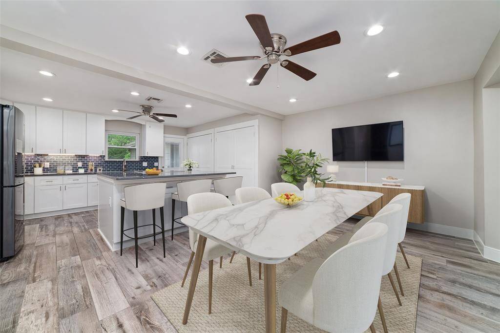 A sleek, modern kitchen featuring abundant lighting, high-end appliances