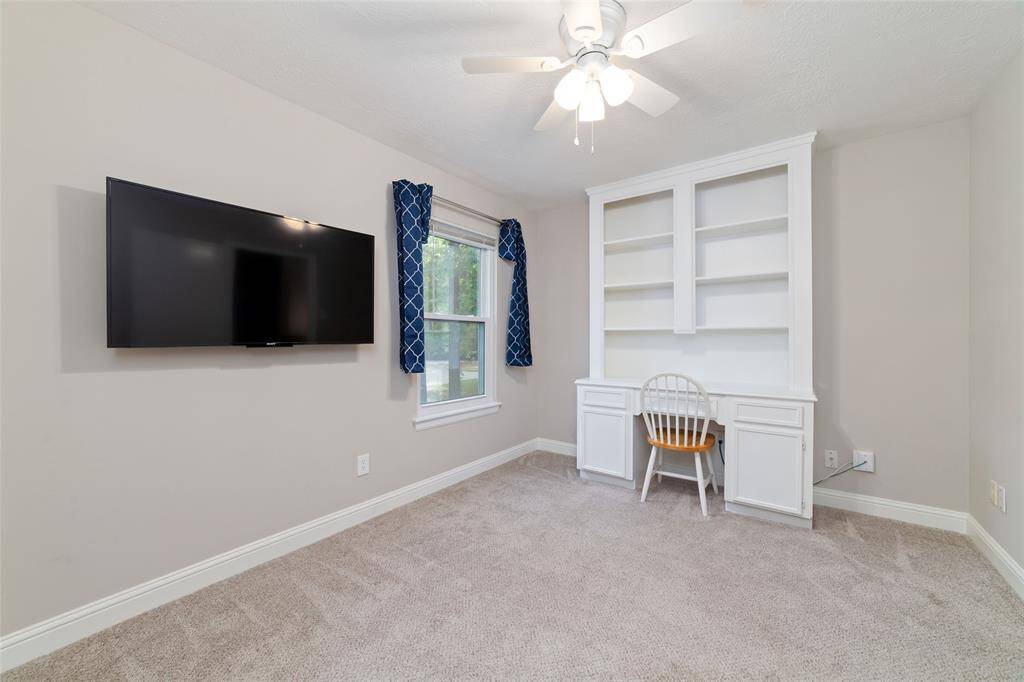 Secondary bedroom with built in bookcase