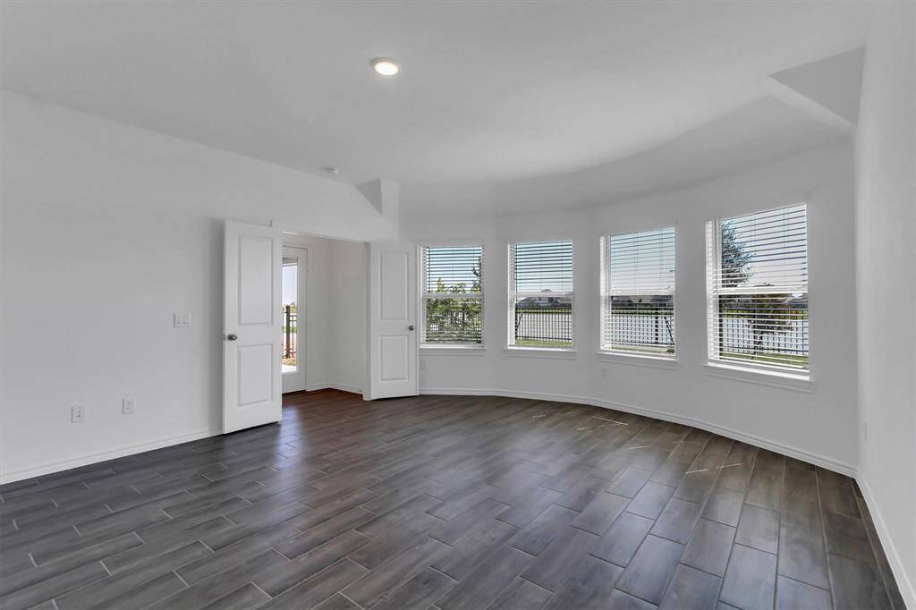 Upgraded bedroom with bay wondows and no carpet.