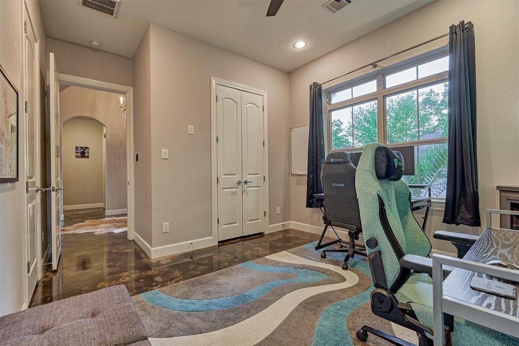 This versatile bedroom offers a spacious walk-in closet and direct access to a full bath, making it ideal for guests or a comfortable home office setup.