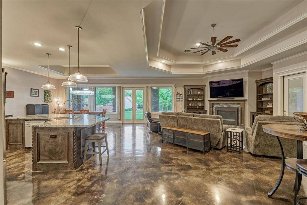 This expansive open-concept living space seamlessly combines the living room, kitchen, and dining area. A large center island anchors the kitchen, providing ample prep space and casual seating.