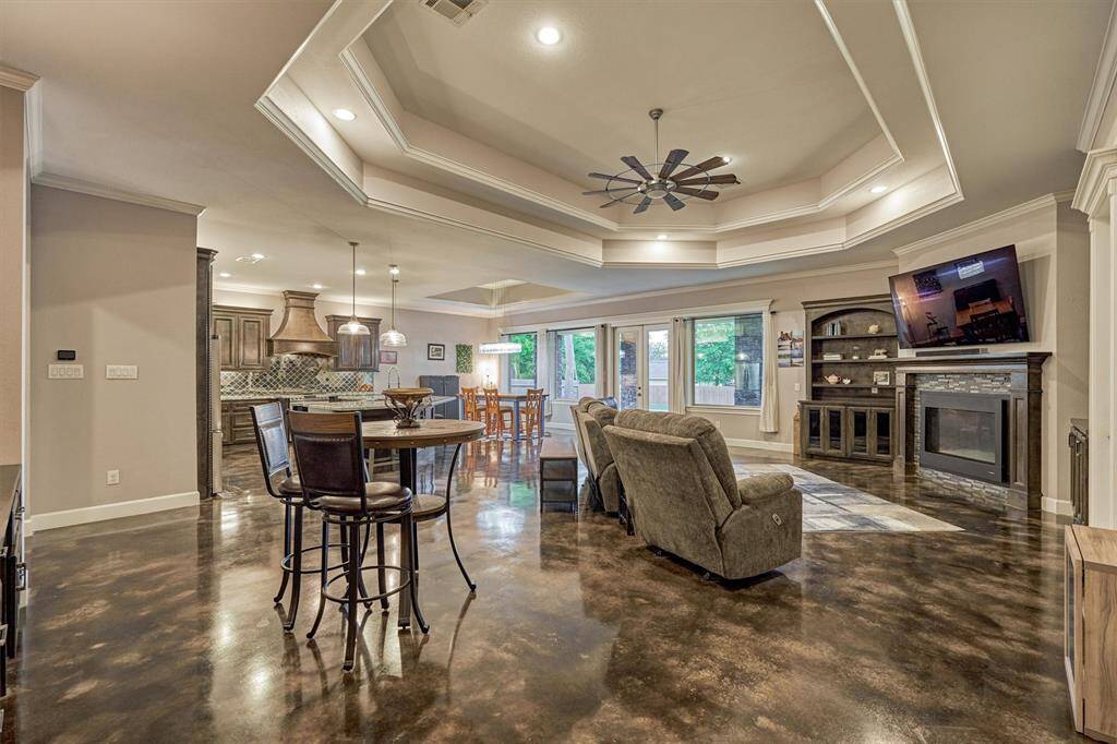 A corner gas fireplace serves as the focal point of the living area, flanked by built-in bookcases and storage cabinets on each side.