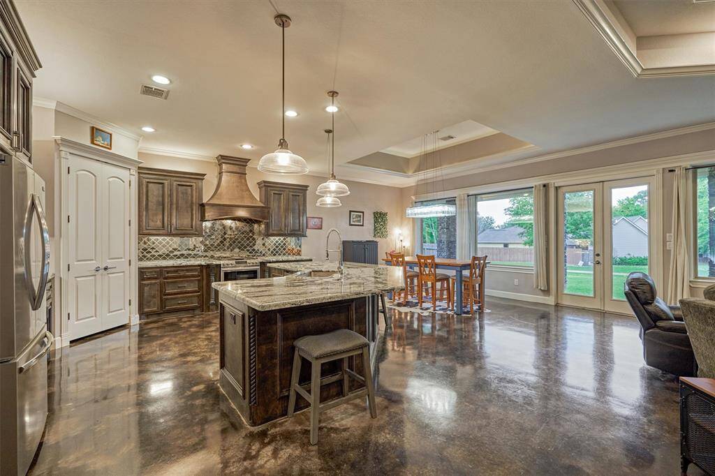 The center island is highlighted by glass pendants and provides additional seating.