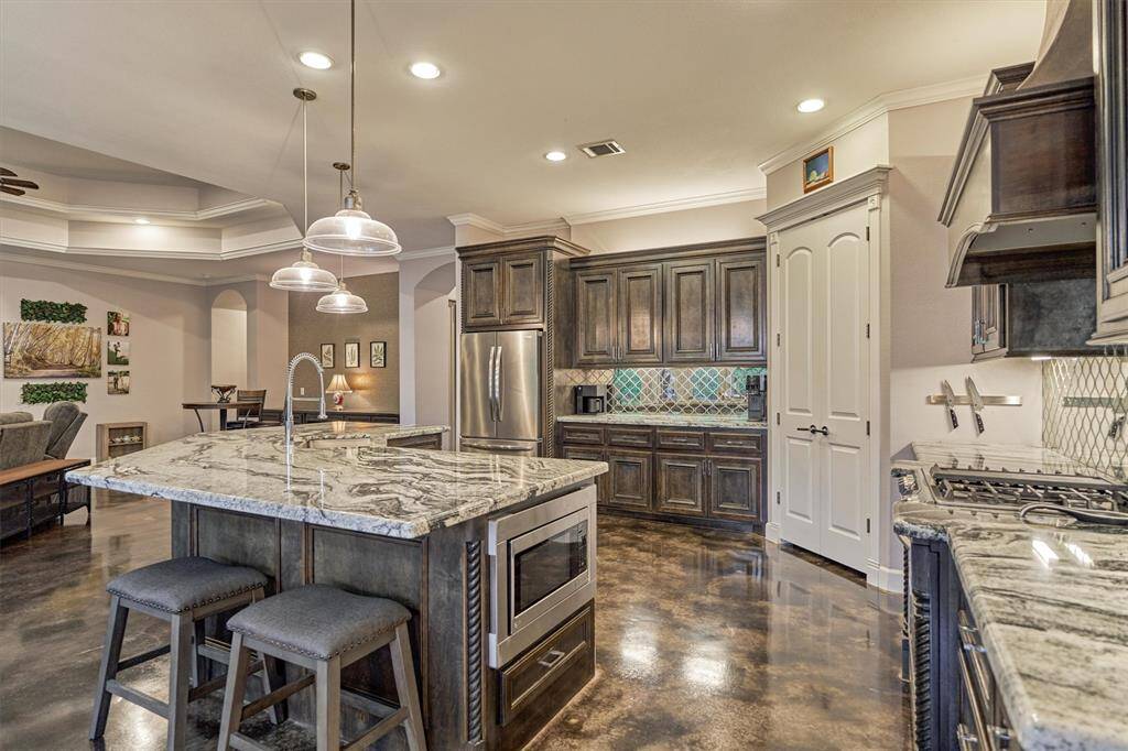 The microwave is thoughtfully tucked away in the center island, maintaining the clean lines of the kitchen while adding convenience and functionality.