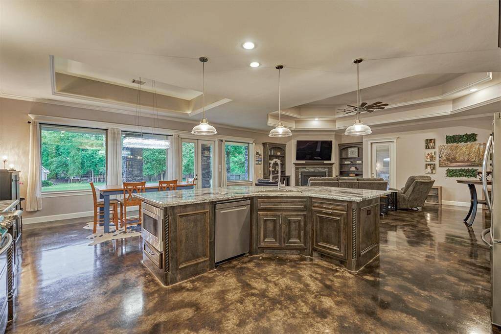 Large picture windows frame stunning views of the backyard and green space beyond, filling the living areas with natural light and creating a seamless connection to the outdoors.