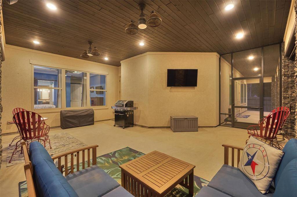 This generously sized patio easily accommodates multiple seating areas, making it perfect for relaxing, entertaining, or enjoying sports games in comfort.