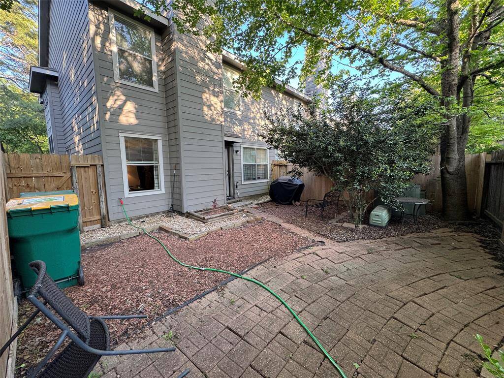 Fenced-in backyard with greenery.
