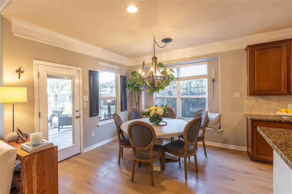 Charming dining space with window seat and view of outdoor living space