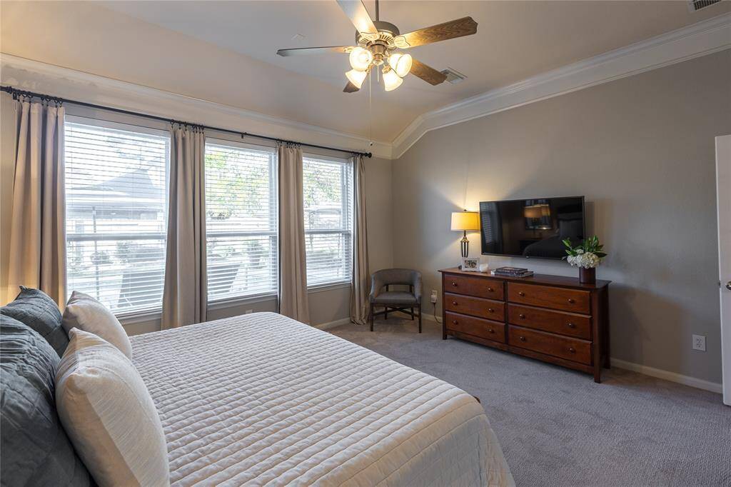 Crown molding and serene colors in primary suite