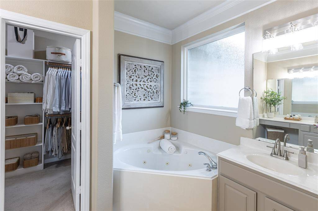 Light and bright primary ensuite with peep at walk in closet