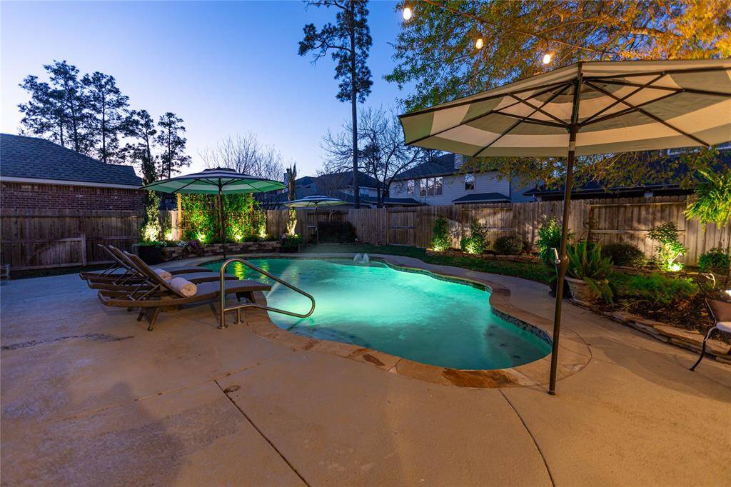 Landscape lighting highlights the area around the pool