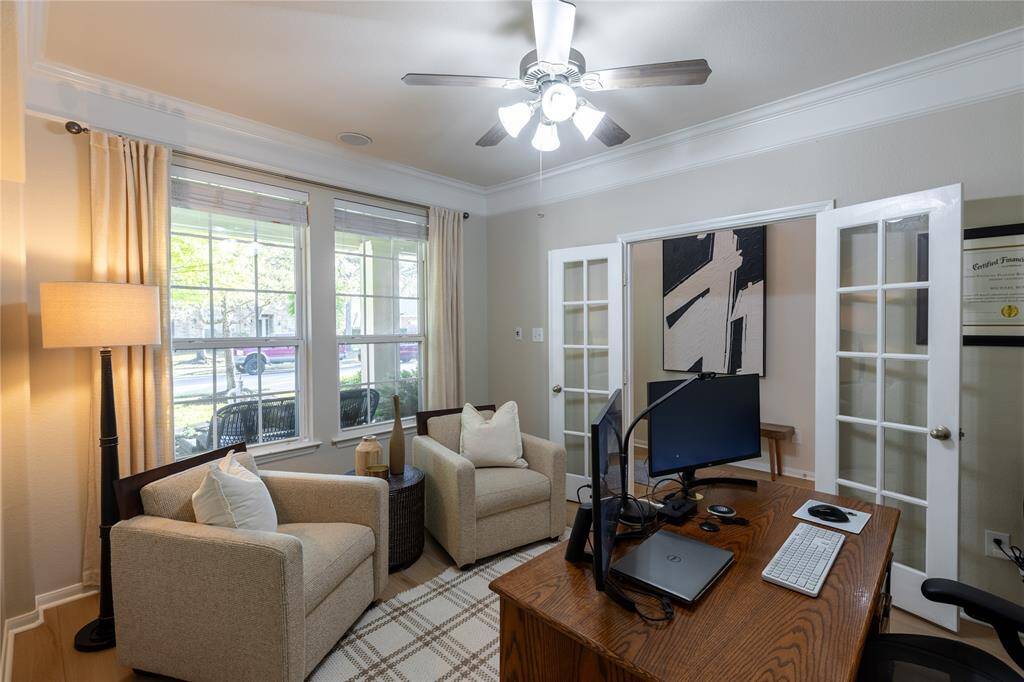 Dining room is being utilized as a study. Also trimmed with crown molding and fashioned with french doors