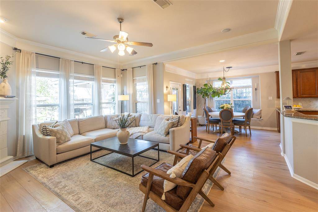 Again, take note of the natural light, crown molding and wide plank floors