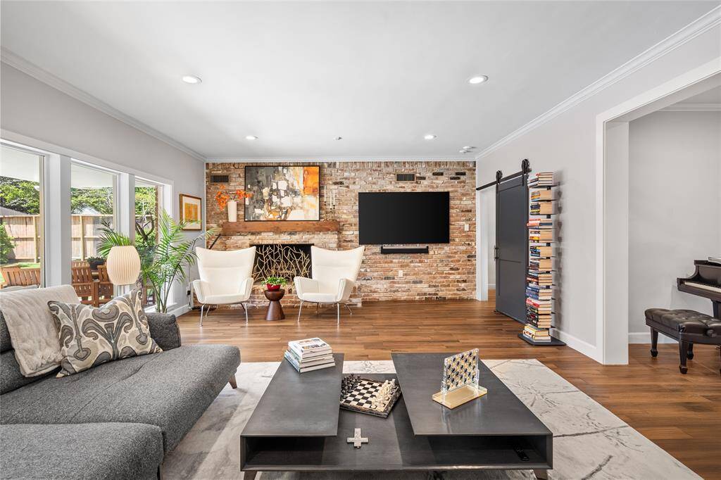 Good-looking brick wall with a gas-log fireplace. The primary suite is through the door to the right.
