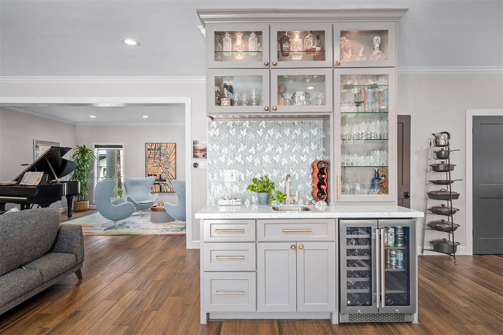 Gorgeous wet bar with wine cooler. Note the glass tile backsplash.
