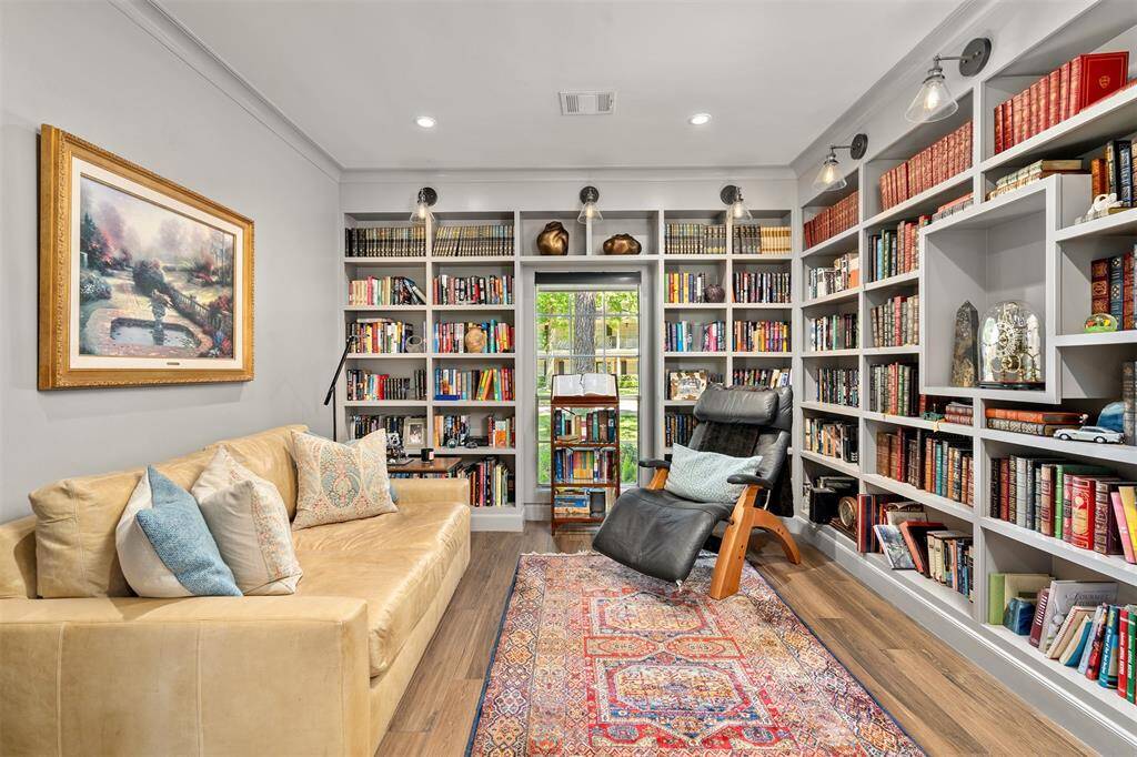 Part of the Primary suite, this handsome library is the perfect place to wind down the day.  Custom-built shelves with elegant sconces.