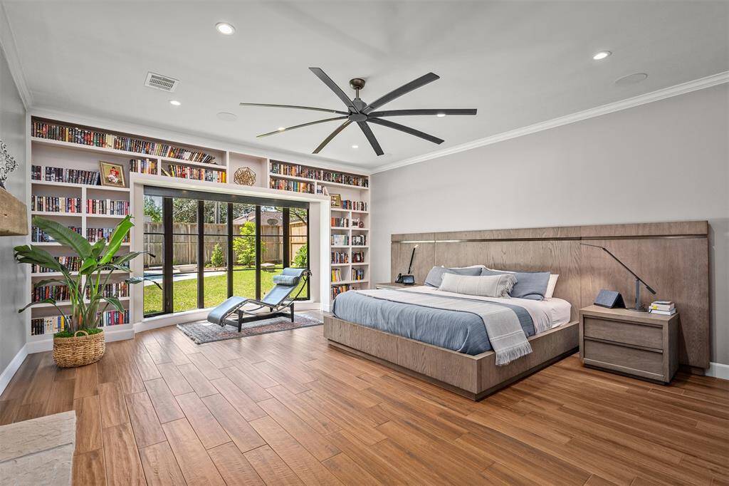 Expansive primary bedroom. Love the bookshelves!