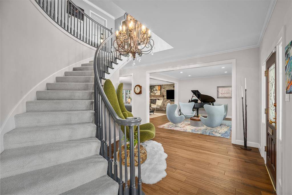 Grand, curved staircase with fabulous formals.