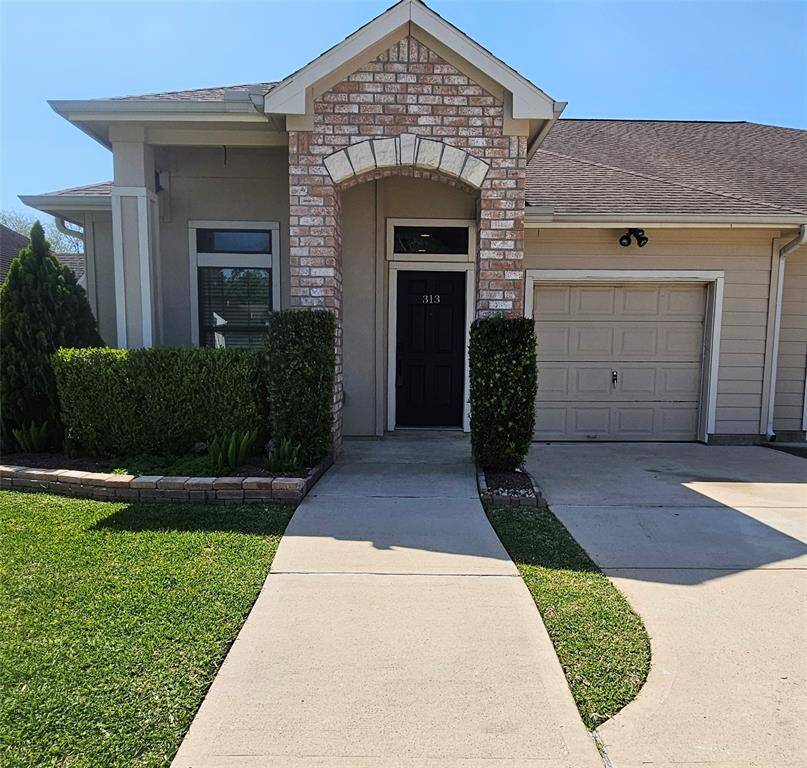 Front View of Unit #313, Assigned Driveway Space and One Car Attached Garage. Lawn Maintenance and Watering Provided by HOA Front and Back
