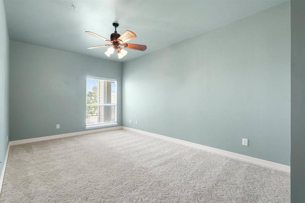 Bright living area perfect for entertaining, featuring a cozy fireplace, patio access and lake views.