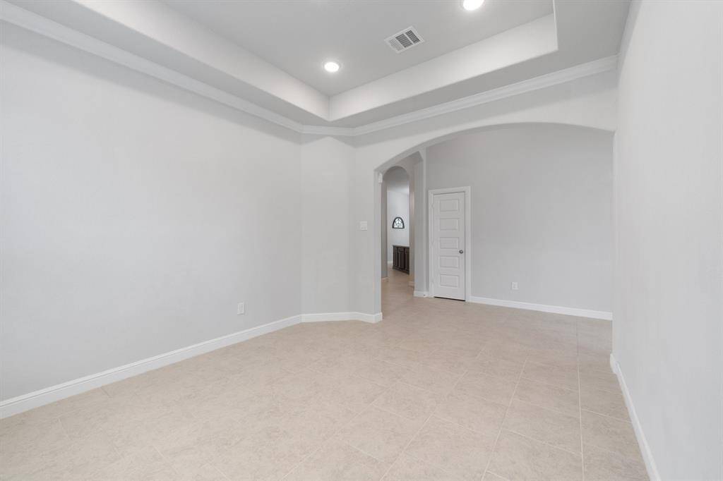 Spacious formal dining area with elegant architectural details and seamless access to the kitchen and main living spaces.