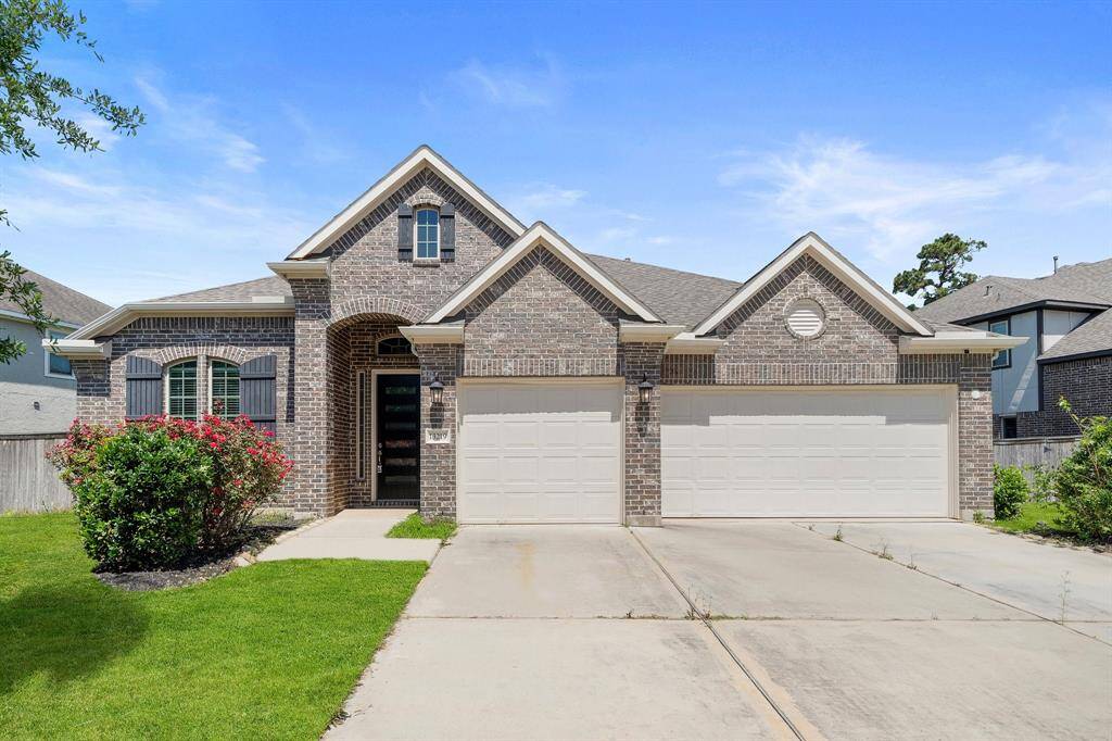 Picture-perfect curb appeal with a 3-car garage and lush landscaping—situated just steps away from the serene lake and walking trail.
