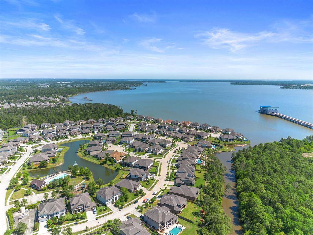 Stunning aerial captures the home's location within a lakeside community, offering peaceful waterfront living and scenic surroundings.