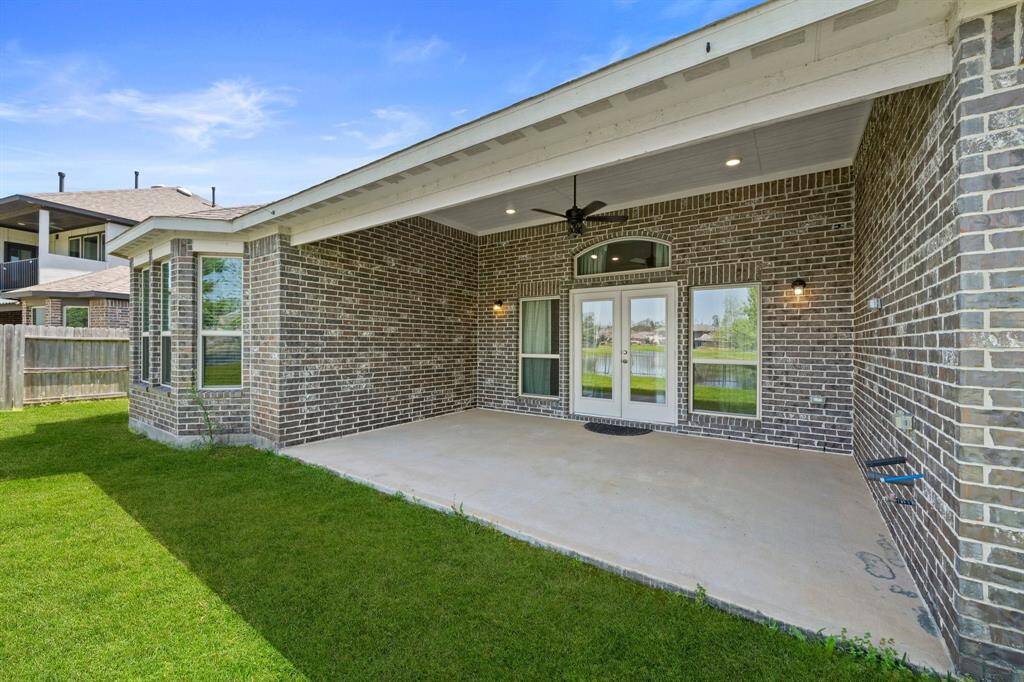 This covered patio offers ample space for outdoor seating or dining, perfect for entertaining while enjoying peaceful water views.
