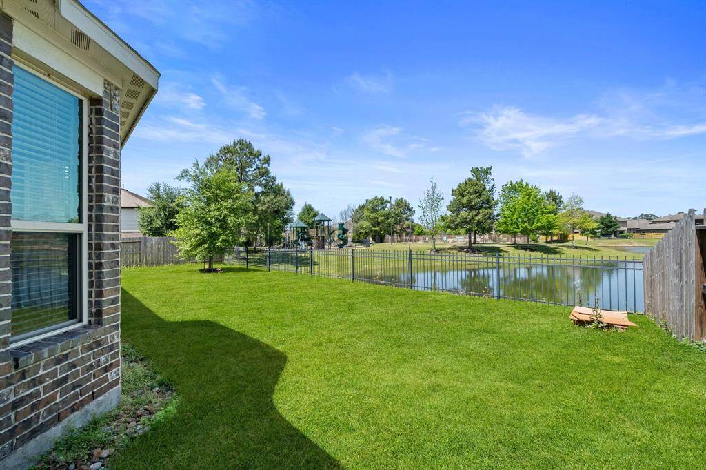 Enjoy a fully fenced yard backing to a scenic lake and neighborhood playground—ideal for both relaxation and outdoor fun.