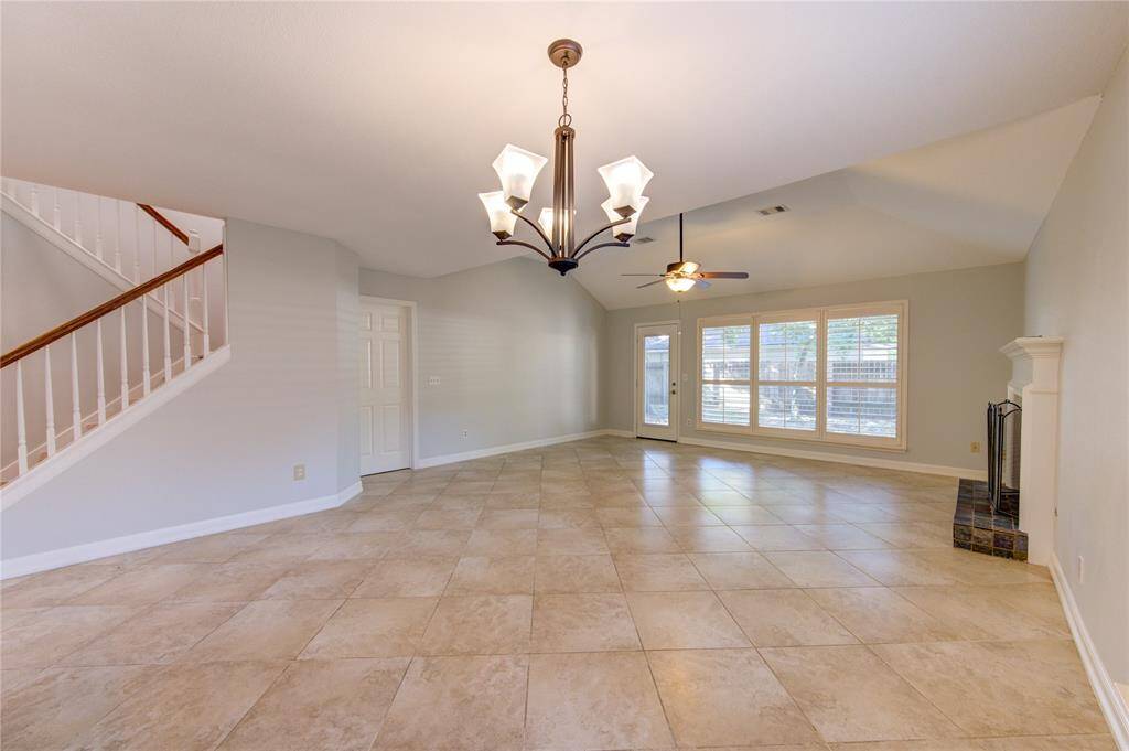 Large open family room and dining area features Plantation shutters.