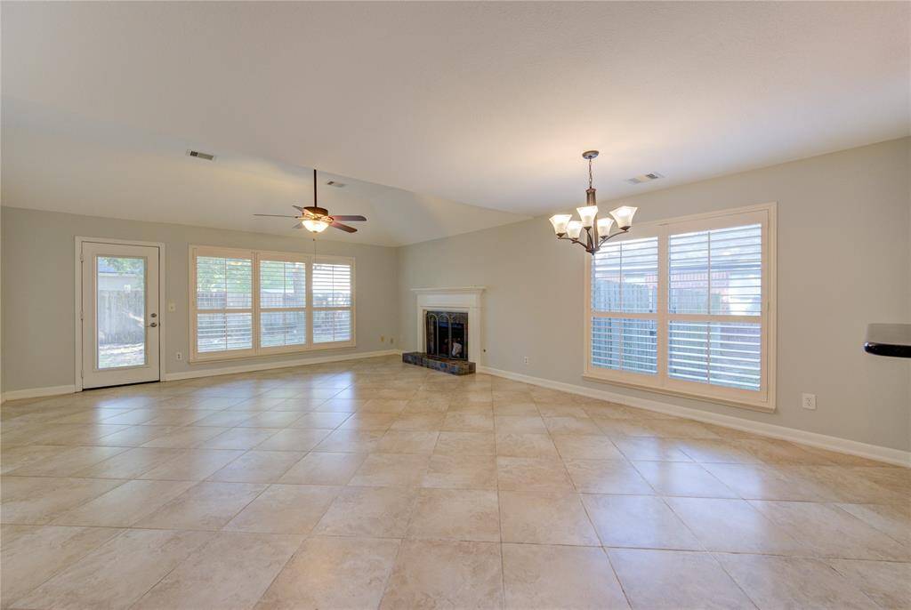 Light and bright family room with gas log or woodburning fireplace