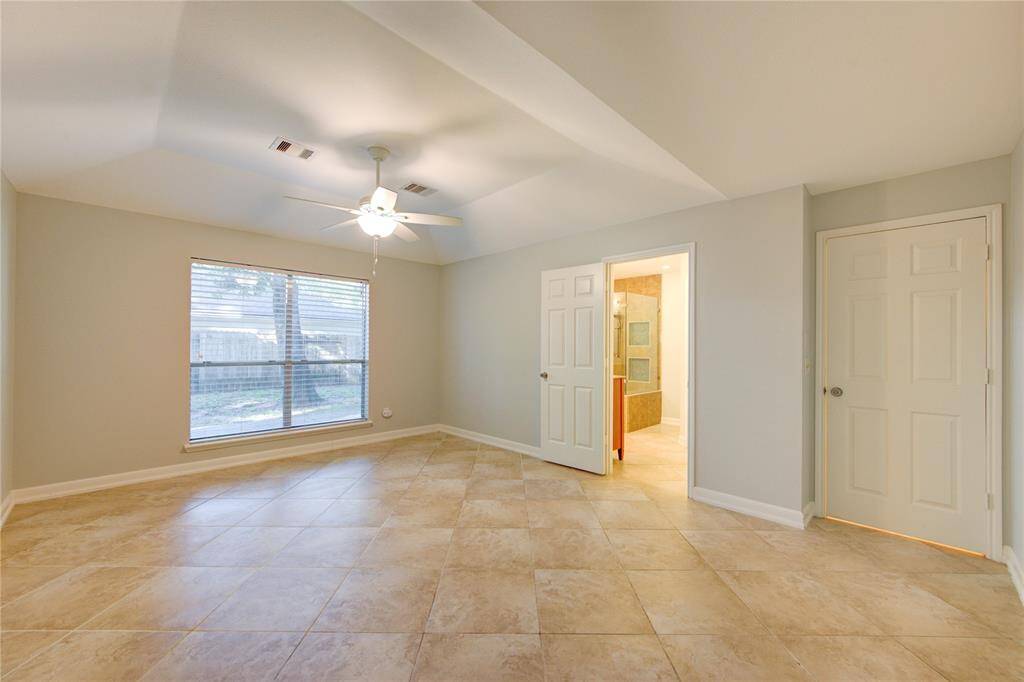 Spacious primary bedroom on 1st floor overlooks backyard.