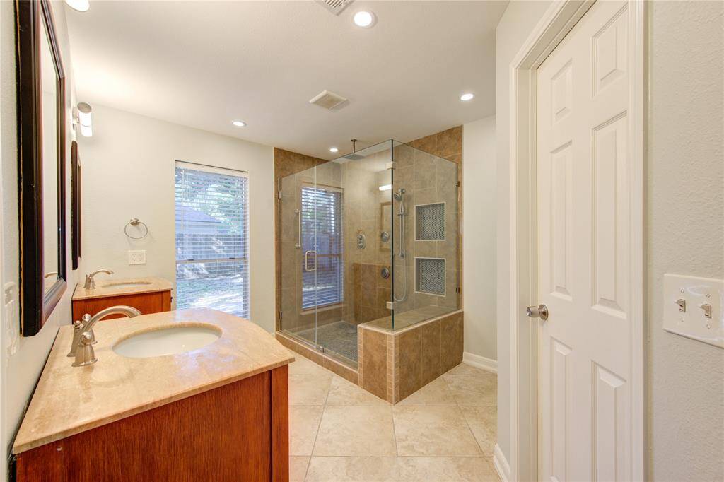Lovely renovated primary bathroom features a large walk-in shower