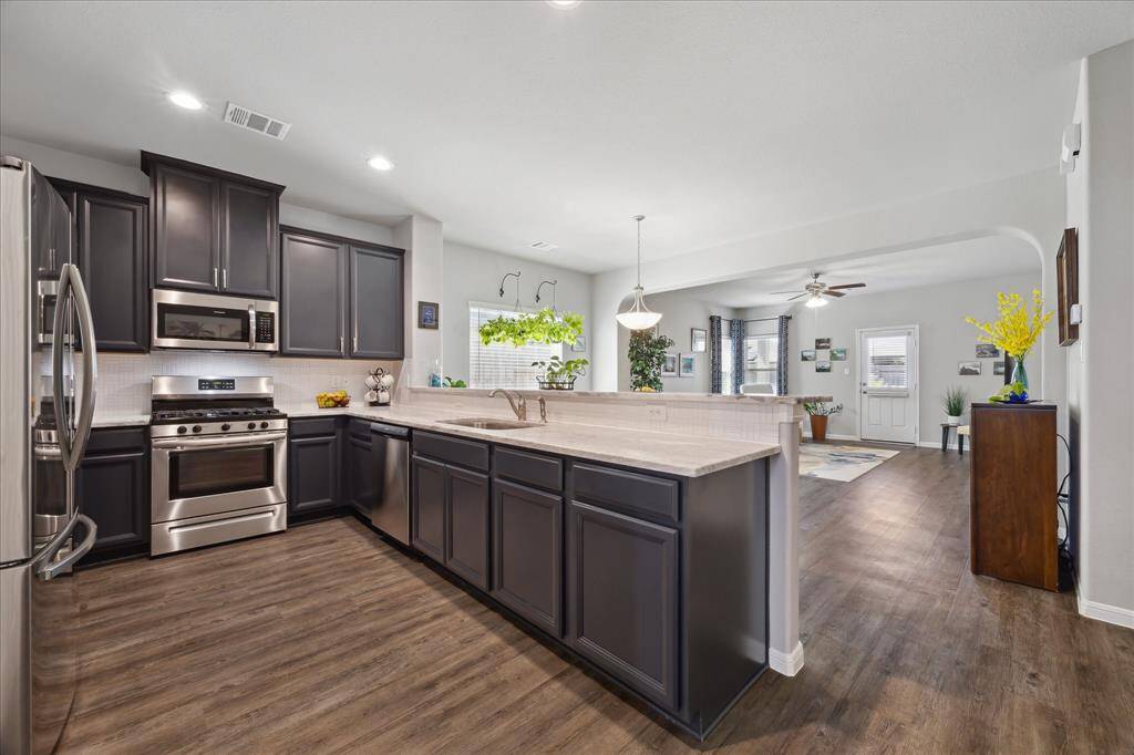 Fabulous Kitchen with  gorgeous granite countertops, showcases full length Breakfast Bar.