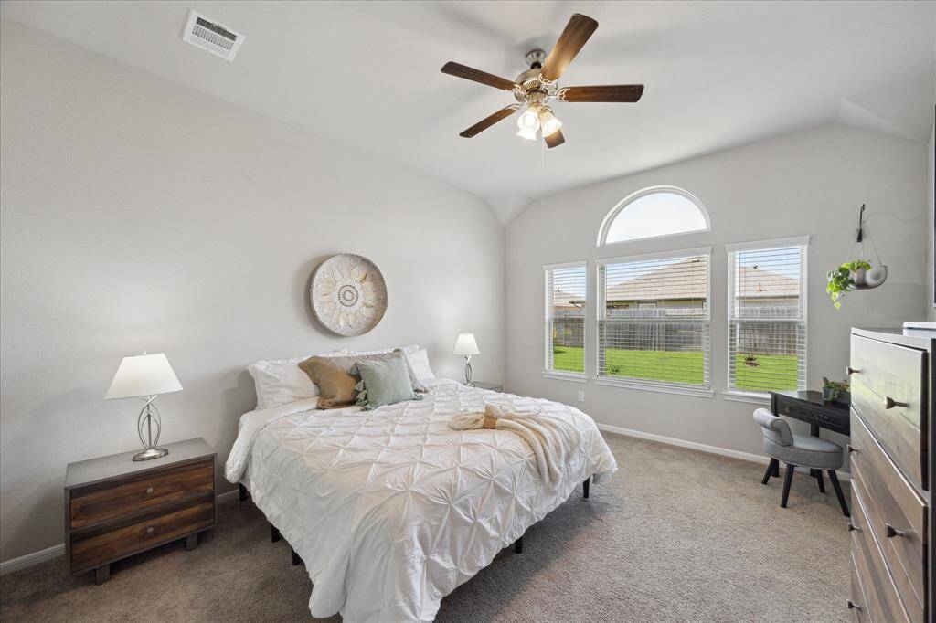 Primary Bedroom with glorious natural light and view of backyard.