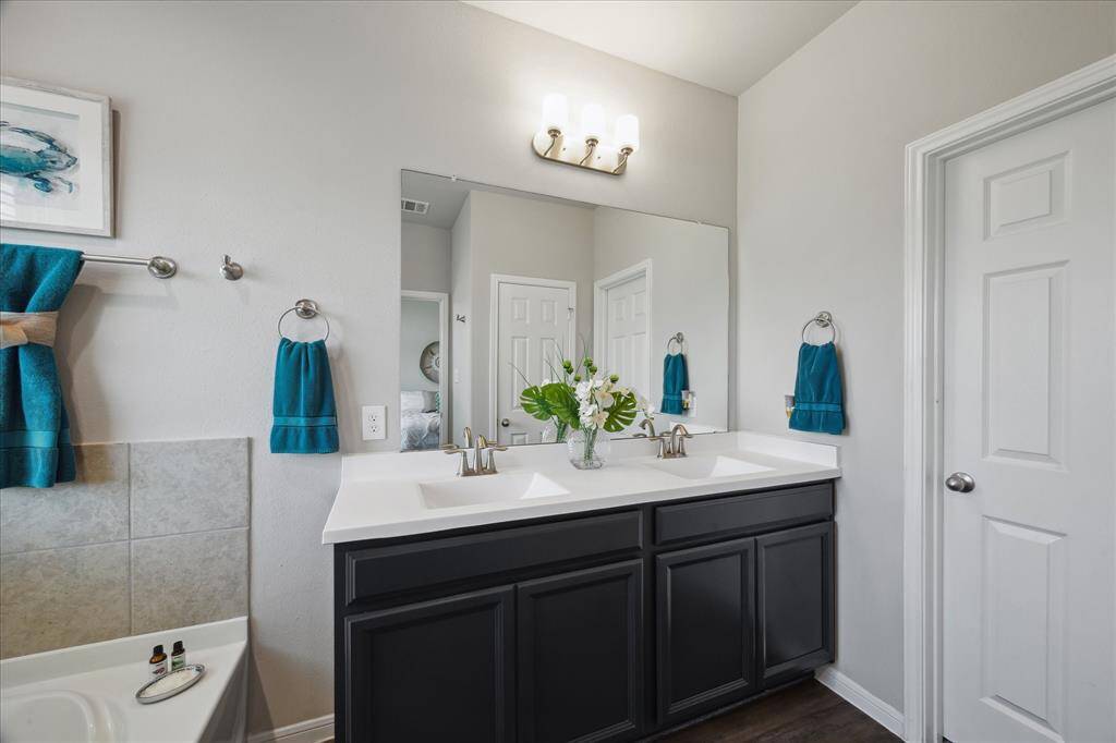 Gorgeous primary bathroom vanity and access to spacious walk-in closet.