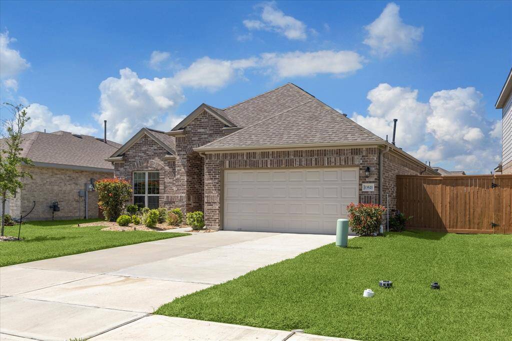 Spacious garage with double-wide driveway.
