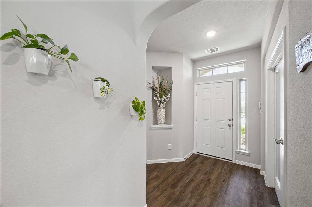 Beautiful neutral palette with warm flowing luxury vinyl plank flooring