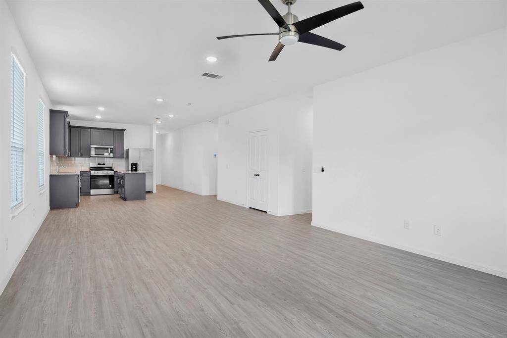 VIEW FROM FAMILY ROOM TO DINING & KITCHEN