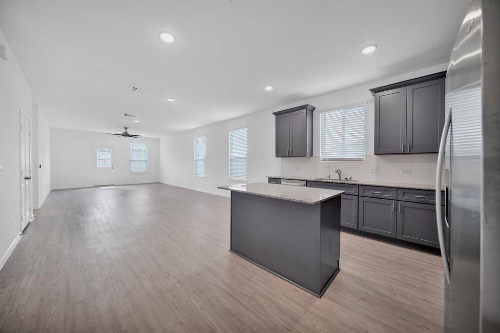 VIEW FROM KITCHEN TO DINING & FAMILY ROOM