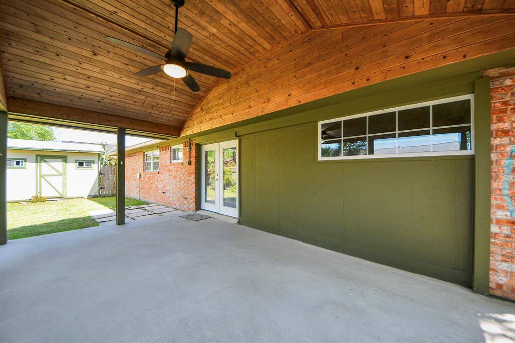 Welcome to 1409 N Park Ridge! This stunning large covered patio, added in 2010, features gorgeous wood decking, a ceiling fan for added comfort, and freshly applied paint, creating the perfect space for outdoor relaxation and entertainment.